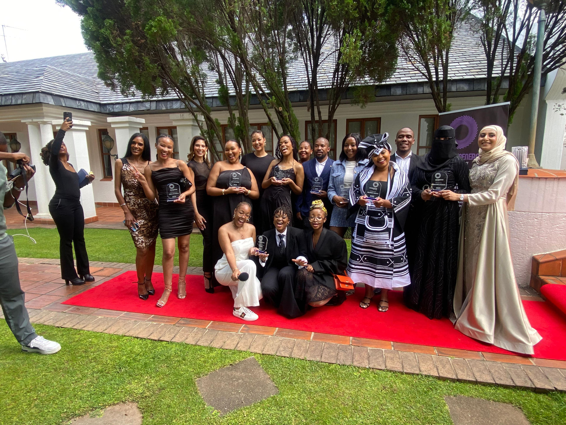 NGBC award winners celebrating with trophies on the red carpet